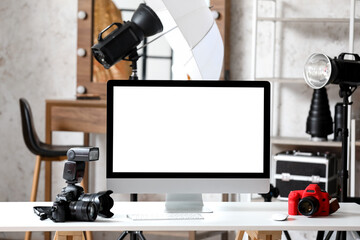 Modern photographer's workplace with computer in studio