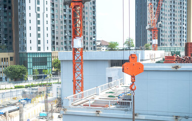 View of the construction site and red cranes for building a modern residential area.