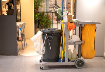 Cleaning tools carts and equipment parked in the walkway in the public area for preparing cleaning.