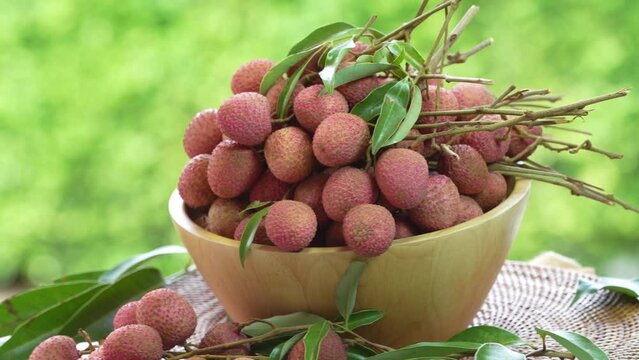 Lychee Fruite in wooden basket, Lychee fruit under sunlight on blurred nature background.