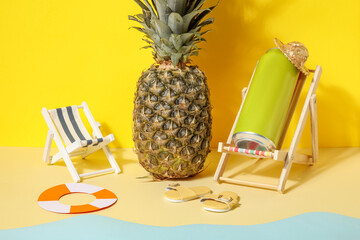 Can of soda with beach decor and pineapple on color background