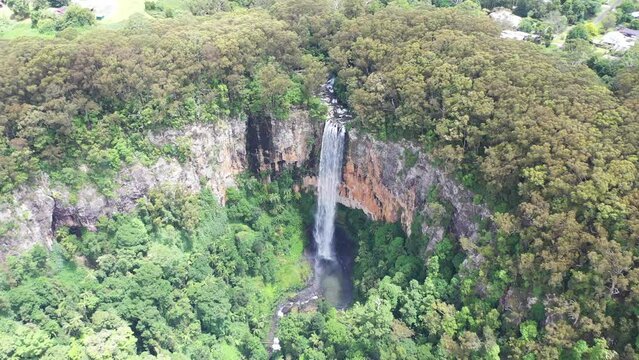 Aerial wide view of Purling Brook falls and lower pool, with a circle back and forth across to each side. Springbrook National Park, Gold Coast hinterland