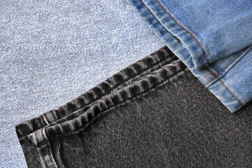 Different stylish denim jeans as background, closeup