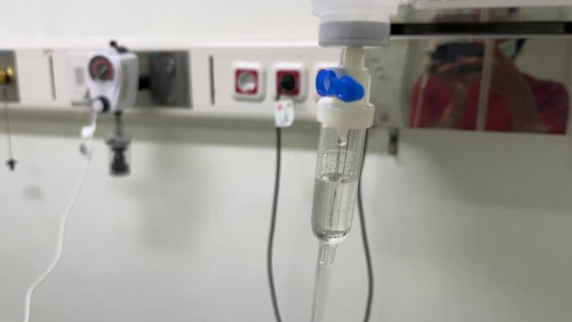 Set of intravenous drop saline drip in a hospital intensive care unit room for patient treatment.