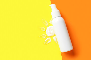 Drawing of sun made with sunscreen cream on color background