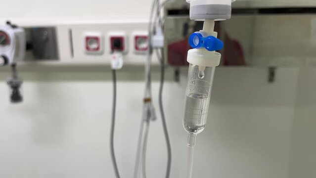 Set of intravenous drop saline drip in a hospital intensive care unit room for patient treatment.