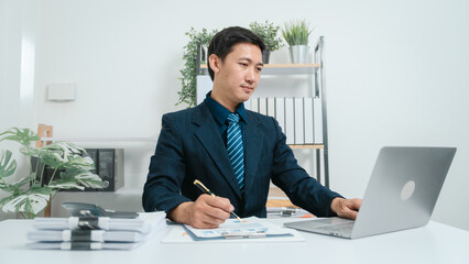 Naklejka premium Young asian business man audit analysis graph company budget report, cash inflow, pension fund, disclosure, assigned accounts receivable, production control, operational audit, cost-plus pricing