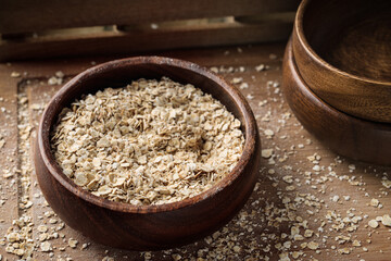 Uncooked oats in a wooden bow