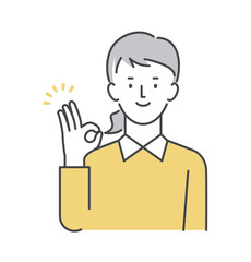 OKポーズをするカジュアルな服装の女性