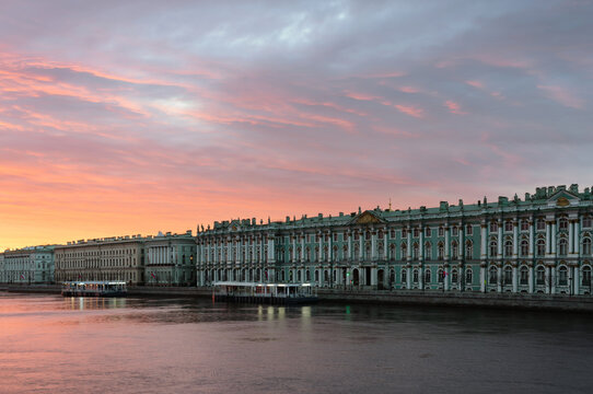 The building of the State Hermitage Museum on the Palace Embankment against the pink dawn sky, St. Petersburg, Russia