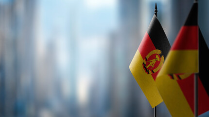Small flags of the GDR on an abstract blurry background