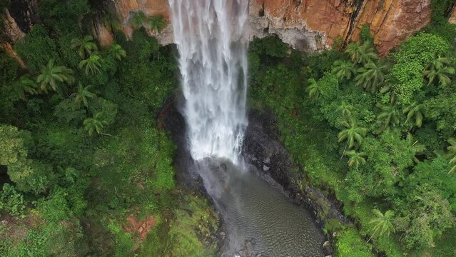 Aerial view ascending Purling Brook falls, ending with a zoom out over the falls, vally and surrounds. Springbrook National Park, Gold Coast hinterland