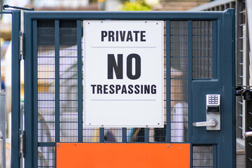A gate leading into a private area with a sign reading 