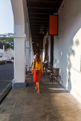 European tourist walking with a backpack in the town of Galle in Sri Lanka
