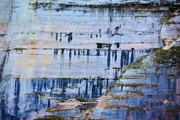 Background Pictured Rocks with minerals dripping like paint down stone cliff face
