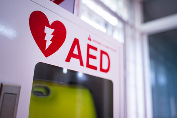 An automated external defibrillator (AED) in a white box is an emergency defibrillator for people...