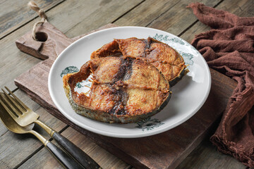 Ikan Tongkol goreng or fried Mackerel Tuna fish. Fried dry with turmeric seasoning.