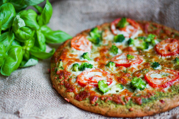 closeup of homemade vegetarian pizza on wooden background
