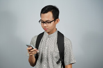 Portrait of a man held smartphone and wear backpack