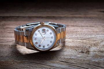 Old luxury wristwatch on old wooden background