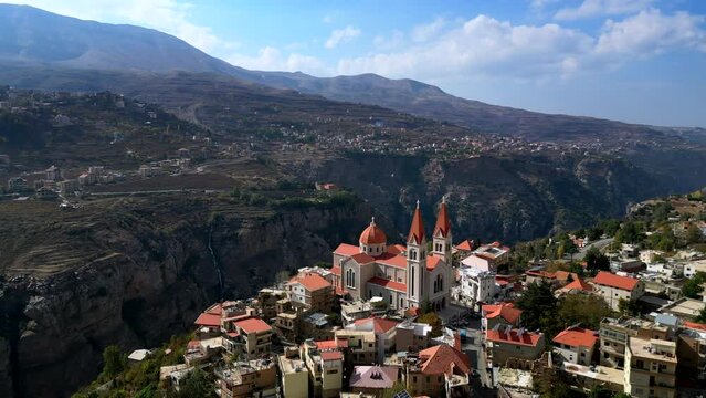 Beautiful drone shot rural town in Lebanon with mountain backdrop