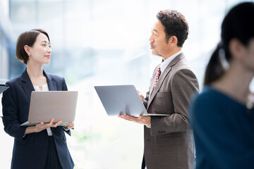 Business scene of a president or responsible person talking to subordinates in a company in a beautifully backlit office building  like a exsective