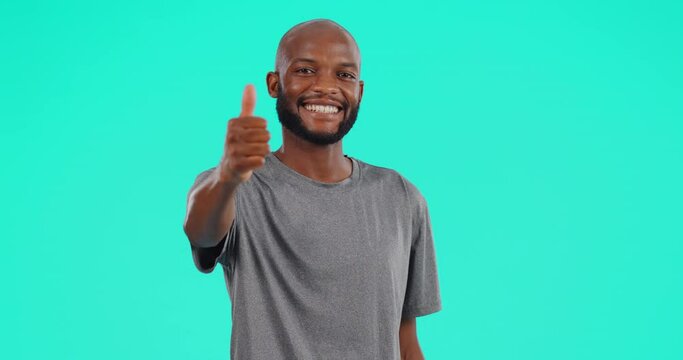 Face, smile and black man with thumbs up in studio isolated on a blue background mockup space. Portrait, like hand gesture and African male person with emoji for success, review or thank you for vote
