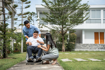 Asian attractive family, parents playing with young son in the garden. 