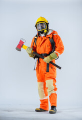 Fototapeta premium Professional firefighter is holding an iron axe with both hands and closing his eyes on a white background.