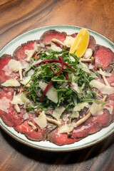 beef Carpaccio with salad and parmesan cheese - 606278027