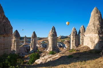 Fototapeta na wymiar Cappadocia Fairy Chimney rock formations, Valley with stones in form of huge phalluses the result of ancient volcanic eruptions, Incredible nature of Turkey
