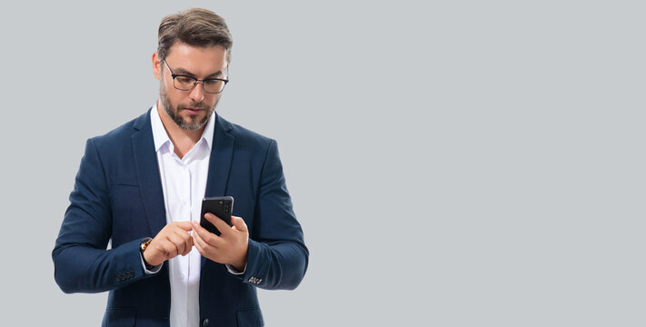 Business man in suit watching on mobile phone. Handsome man using smart phone, type sms message. Social network. Banner for header, copy space. Poster for web design.