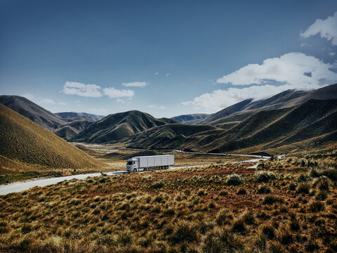 Scenic Summer Journey: Semi-Truck Amidst South American Hills