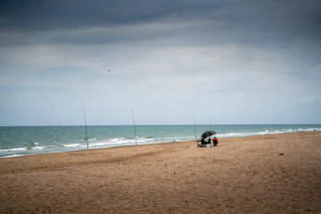 person fishing on the beach