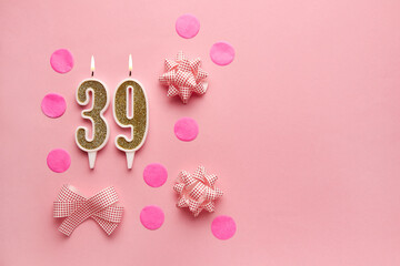 Number 39 on pastel pink background with festive decor. Happy birthday candles. The concept of celebrating a birthday, anniversary, important date, holiday. Copy space. Banner