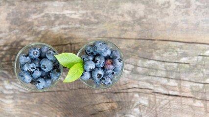 Ripe blueberries on a wooden background. Fruit appetizing background.