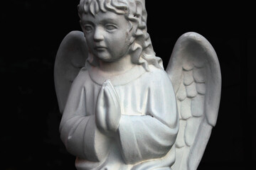 Figure of a praying angel in the cemetery. Horizontal image.