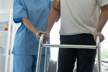 A physiotherapist helps a male walker patient with physiotherapy treatment and health care insurance.