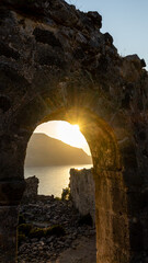 The sun shines through an ancient arch on the island of Gemiler (Saint Nicholas) in the Aegean Sea