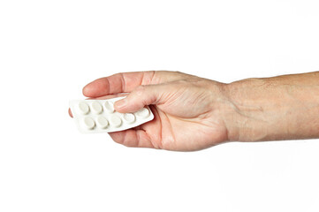 Men's hand holding white pills in common tablets shape isolated on white background. Hand with pills, closeup