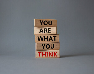 You are what you think symbol. Wooden blocks with words You are what you think. Beautiful grey background. Business and You are what you think concept. Copy space