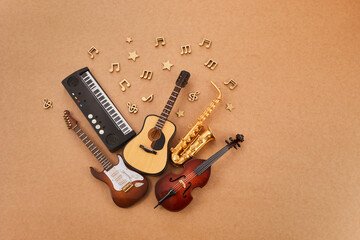 Happy world music day. Musical instruments on brown background.