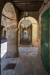 Fototapeta na wymiar The ancient arcades of the medieval village of Urbania in the Marche region of Italy