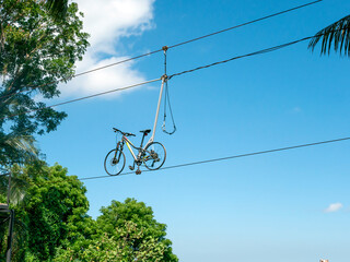 A zipline bike in Pule Payung Hill, Kulon Progo, Indonesia, with blue sky background