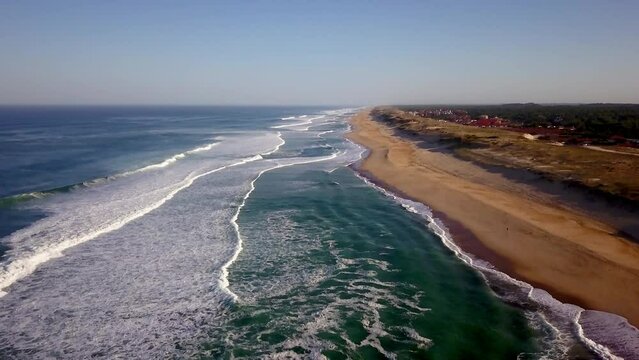 Aerial drone cinematic sunrise early morning waves crashing stunning beachfront Hoosegor Capbreton Biarritz France Europe Bay of Biscay WSL Quiksilver Pro central Peronze sunny midday down movement