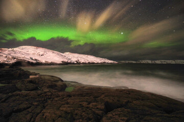 Fototapeta na wymiar night landscape with northern lights and aurora winter by the sea