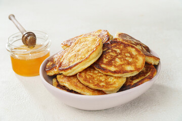 Delicious pancakes with honey for breakfast, close-up home cooking
