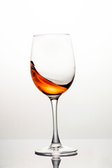 Splash of wine in a glass, motion blur, frozen wine motion