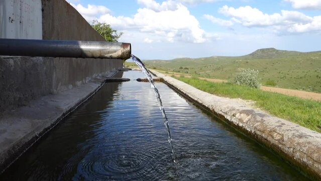 close-up of drinking water fountain flowing from the pipe,clear water flows from the fountain,