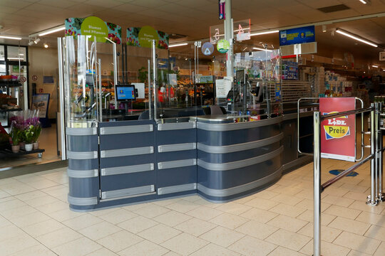 Uelsen, Germany May 16 2023 An unused checkout desk at the Lidl. The cashieres are protected against viruses by large plastic walls since covid